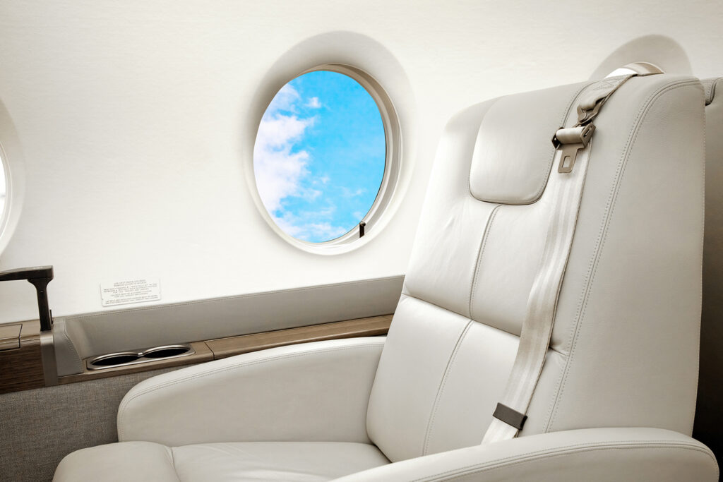 aircraft-jet-business-class-interior-with-blue-sky-outside-porthole edit