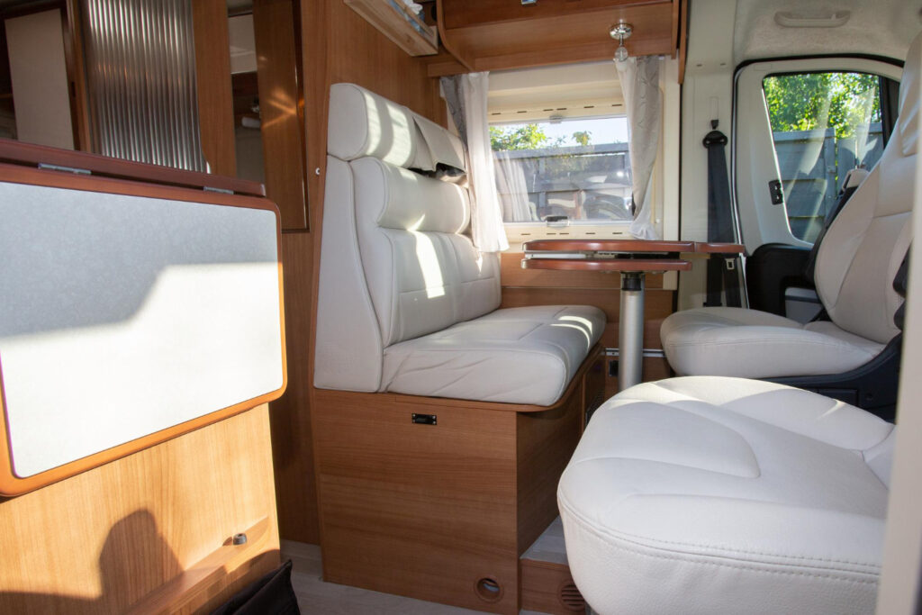 camper-dining-room-place-with-wooden-white-interior-front-van-seat-vanlife