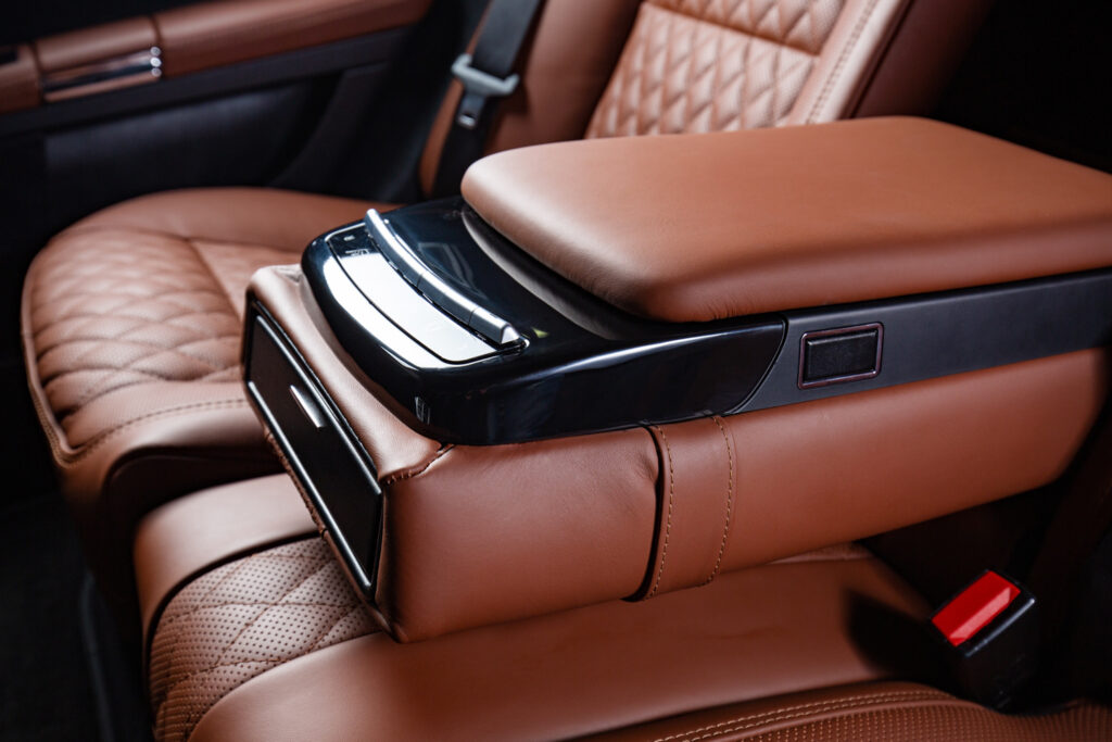 A luxury car interior in brown and black colors